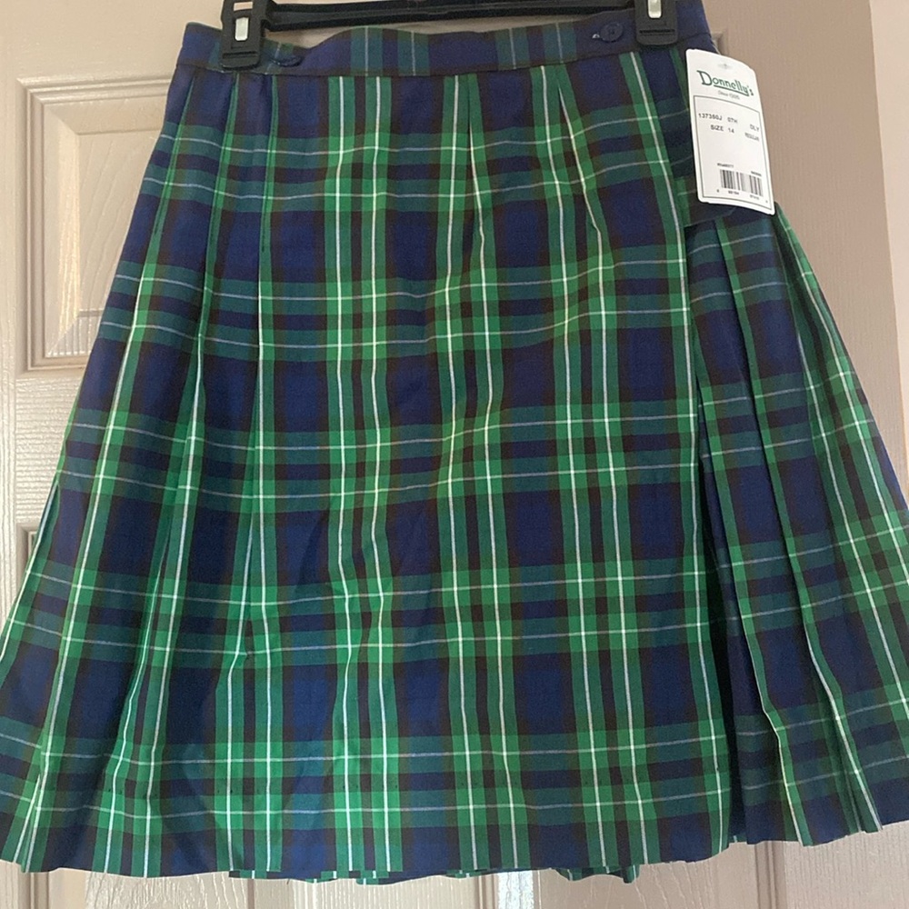 Brand new Lincoln school girl’s Donnelly’ uniform.Navy/green kilt